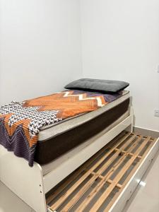 a bed with a blanket on top of it at Casa Paraty espaçosa próximo ao centro histórico in Paraty