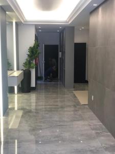 a hallway of an office building with a person in the background at Baltico302 in Capão da Canoa