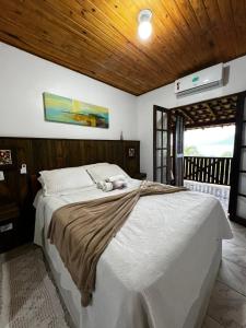 Postel nebo postele na pokoji v ubytování Pousada Cantinho D'Abrantes - Próximo as Melhores Praias de Ilhabela - Veloso e Curral