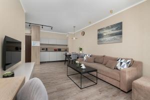 a living room with a couch and a table at BelMare Aqua Resort by Solarento in Międzyzdroje