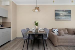 a living room with a table and a couch at BelMare Aqua Resort by Solarento in Międzyzdroje +97 photos