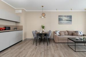 a living room with a couch and a table at BelMare Aqua Resort by Solarento in Międzyzdroje