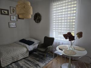 a small bedroom with a bed and a table and a table sidx sidx at Apartamenty CAPPUCCINO in Przemyśl
