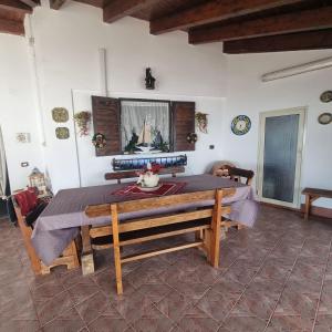 a dining room with a table with a table cloth at Villa Eden in Porto Empedocle +29 photos