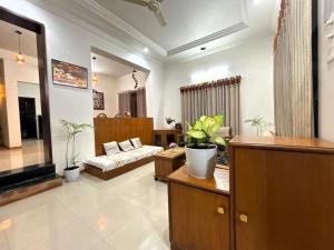 a living room with a couch and a table at Tranquil Trails-Sharvari Villa-Nashik in Nashik