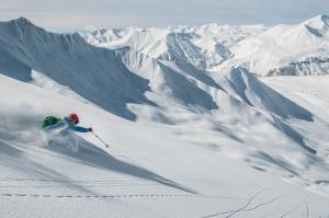 a person is skiing down a snow covered mountain at Very cozy 2 Room apart NEW GUDAURI, LOFT 2, apt 223 in Gudauri