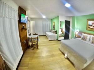 En eller flere senge i et værelse på Pousada Aargau