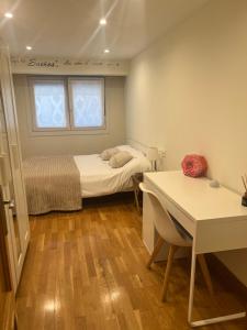 a bedroom with a bed and a table and a window at Casa del bienestar in Bermeo