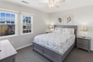 a bedroom with a bed and two windows at CAC-17A - Sailfish in Buxton