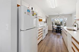 a kitchen with a white refrigerator and a table at CAC-21A - Turtle in Buxton