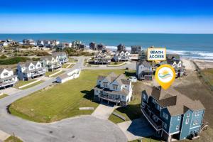 an aerial view of a beach with houses and the ocean at CAC-22A - Whale in Buxton +42 photos