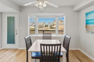 a dining room with a table and chairs and a window at CAC-3B - Cobia in Buxton