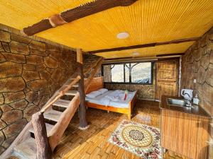 a bedroom with a bed and a sink in a stone wall at TOWER Hotel in Dana