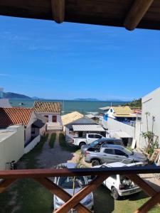 a view from a balcony of a town with cars parked at Casas no Centro Histórico de Garopaba in Garopaba