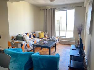 a living room with a couch and a table at Luyindalo Accomodation at Granten Heights in Summerstrand