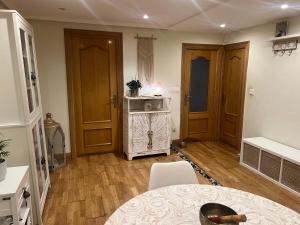 a room with a kitchen with a table and a microwave at Casa del bienestar in Bermeo