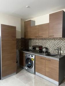 a kitchen with a washing machine and a sink at Tiba Golden Resort in Hurghada