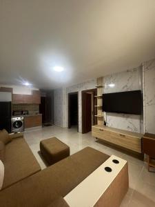 a living room with a couch and a flat screen tv at Tiba Golden Resort in Hurghada +22 photos