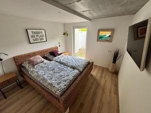 a bedroom with a wicker bed and a window at Family Beach Appartement Laboe in Laboe