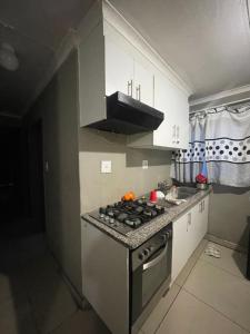 a kitchen with a stove and a counter top at Mbombela Stay in Nelspruit