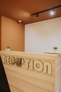 a reception desk with the regolith sign on it at Gallus Inn in Aleksinac