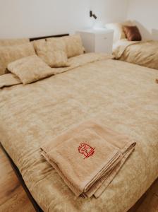 a bed with a towel on top of it at Gallus Inn in Aleksinac