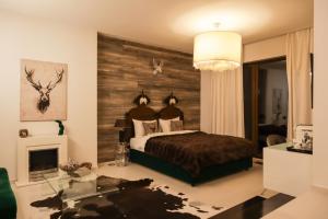 a bedroom with a bed with a wooden wall at Relax in Style Boutique Hotel in Braşov +62 photos