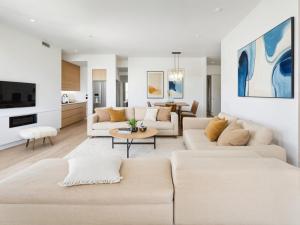a living room with two couches and a tv at Stylish Urban Escape in Downtown Los Angeles in Los Angeles
