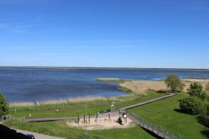 a park with a view of a body of water at Ezerkrasta Apartment in Liepāja