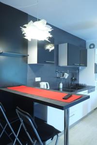 a kitchen with a counter with chairs and a table at Apartman Gala in Čakovec
