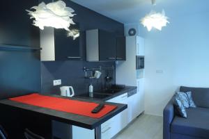 a kitchen with a red counter top in a room at Apartman Gala in Čakovec