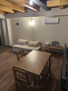 a living room with a table and a couch at Naš duam in Stregna +11 photos