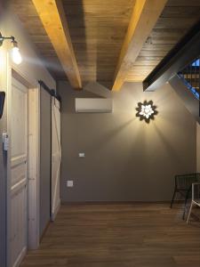 a room with a ceiling with a light on the wall at Naš duam in Stregna