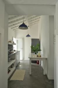 una cocina blanca con mesa en una habitación en Monte dos Pensamentos - Turismo Rural, en Estremoz