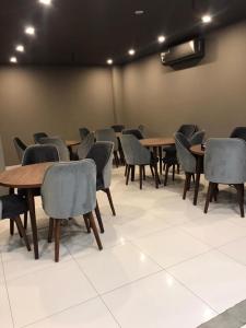a conference room with wooden tables and chairs at Hotel Crossroads in Islamabad