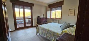 a bedroom with a bed and a dresser and windows at Raggio Di Sole in Cosenza