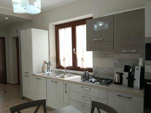 a kitchen with a sink and a stove top oven at Casa vacanza P&G in Laino Castello
