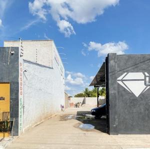 a building with a door with a arrow painted on it at Pousada Cajueiro in Juazeiro do Norte