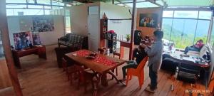 a man standing in a room with a table at Hacienda & Reserva Monterrico in Romilda