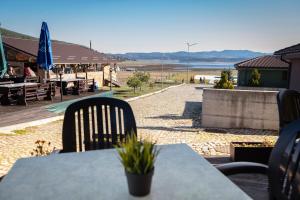 a table and chairs with a view of a beach at Hotel LaCasa Tsigov Chark in Batak