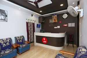 a waiting room with chairs and a reception counter at Collection O KIIT Square Bhubaneswar Formerly Nilay Classic in Bārang