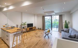 a kitchen and living room with a couch and a table at arvangroup-apartments in Nafpaktos
