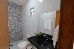 een badkamer met een zwarte wastafel en een toilet bij Casa-Quarto Parnaíba in Parnaíba
