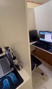 a room with a desk with a laptop computer on it at Upskill Coworking Space in Marilao