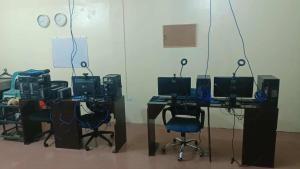 a room with two desks with computers and chairs at Upskill Coworking Space in Marilao