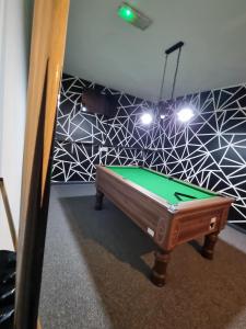 a snooker table in a room with a ceiling at South Beach Kings Promenade Hotel in Blackpool