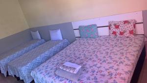 two beds in a room with a bedskirtspectspectssenalsenalsenalsenalsenal at JR POUSADA in Morro do Chapéu +4 photos