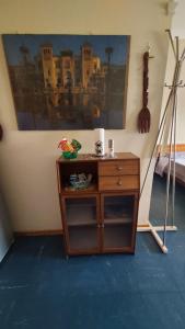 a room with a wooden dresser with a painting on the wall at Nonna Liliana in San Lorenzo al Mare