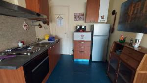 a kitchen with a sink and a refrigerator at Nonna Liliana in San Lorenzo al Mare