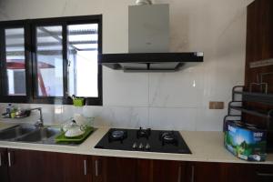 a kitchen with a sink and a stove at Naisoso Island Villa - Fiji in Nadi +63 photos